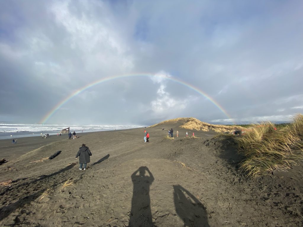 a full rainbow over the beach