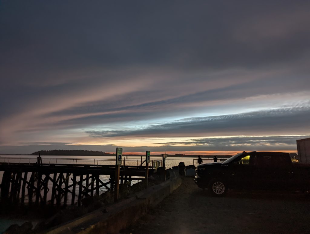 A truck parked at the bay towards the end of sunset